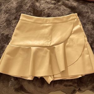 Leather cream colored skort! Has a flap that flares for the skirt/skort part!
